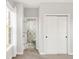Hallway with closet and access to the bathroom showcasing a patterned shower curtain at 17294 W 60Th Ct, Arvada, CO 80403