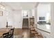 Inviting interior view showcasing hardwood floors, stairs, and a kitchen bar with granite countertops at 17294 W 60Th Ct, Arvada, CO 80403