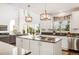 Bright kitchen with a center island, granite countertops, and large windows at 17294 W 60Th Ct, Arvada, CO 80403
