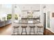 Open concept kitchen featuring a spacious island with seating and modern lighting at 17294 W 60Th Ct, Arvada, CO 80403