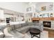 Open-concept living room and kitchen with cozy fireplace and modern furnishings at 17294 W 60Th Ct, Arvada, CO 80403
