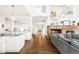 Open-concept layout with kitchen island, fireplace, and staircase at 17294 W 60Th Ct, Arvada, CO 80403