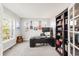 Well-lit home office with a modern desk, guitars, and a built-in bookshelf at 17294 W 60Th Ct, Arvada, CO 80403