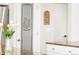 View of pantry door, next to a white door and white cabinets at 17294 W 60Th Ct, Arvada, CO 80403