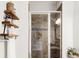 Modern shower stall with brown tile, glass door, and decorative shelving at 17294 W 60Th Ct, Arvada, CO 80403