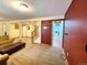 Finished basement featuring a large couch, stairs, and a view into the laundry room at 2418 W Euclid Ave, Littleton, CO 80120