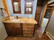 Bathroom vanity featuring granite counters, undermount sink, and decorative framed mirrors at 2418 W Euclid Ave, Littleton, CO 80120