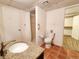 Neutral bathroom with a shower, toilet, sink, and tile flooring at 2418 W Euclid Ave, Littleton, CO 80120