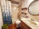 Bathroom featuring vanity with oval mirror, tub shower, and linen closet at 2418 W Euclid Ave, Littleton, CO 80120