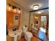 Cozy bathroom featuring wood accents, pedestal sink, and mirrored wall at 2418 W Euclid Ave, Littleton, CO 80120