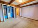 Bedroom with exposed wood beams, neutral carpet, and a closet system at 2418 W Euclid Ave, Littleton, CO 80120