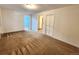 Carpeted bedroom with two doorways and a closet in a neutrally painted room at 2418 W Euclid Ave, Littleton, CO 80120