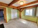Spacious bedroom with exposed beams, carpet flooring, and natural light at 2418 W Euclid Ave, Littleton, CO 80120