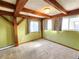 Bedroom featuring exposed wood beams, plush neutral carpet, and natural light at 2418 W Euclid Ave, Littleton, CO 80120