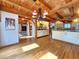 Elegant dining room with wood floors, exposed beams and a stylish chandelier, adjacent to a modern kitchen at 2418 W Euclid Ave, Littleton, CO 80120