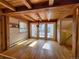 Sunlit dining room with wood floors and French doors, featuring a chandelier and exposed wood beams at 2418 W Euclid Ave, Littleton, CO 80120