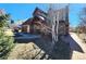Beautiful landscaped front yard, complemented by a brick driveway and lush greenery for enhanced curb appeal at 2418 W Euclid Ave, Littleton, CO 80120