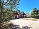 Inviting exterior with lush green trees surrounding the well-maintained lawn and beautiful landscaping, enhancing curb appeal at 2418 W Euclid Ave, Littleton, CO 80120