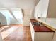 Bright kitchen with ample natural light from skylights, featuring tile floors and red countertops at 2418 W Euclid Ave, Littleton, CO 80120