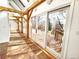 Bright sun room with brick floors, wooden beams, and sliding glass doors to deck at 2418 W Euclid Ave, Littleton, CO 80120