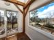 Sun room with wooden beams, view of backyard, and access to wooden deck at 2418 W Euclid Ave, Littleton, CO 80120
