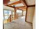 Carpeted upper landing with wooden beams and natural light from multiple windows at 2418 W Euclid Ave, Littleton, CO 80120