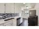 Modern kitchen featuring white cabinets, stainless steel appliances, and backsplash at 2865 S Fairfax St, Denver, CO 80222
