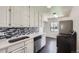 Bright kitchen features white cabinetry, stainless steel appliances, and a mosaic backsplash at 2865 S Fairfax St, Denver, CO 80222