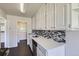 Beautiful kitchen with white cabinets, stainless steel appliances and mosaic tile backsplash at 2865 S Fairfax St, Denver, CO 80222