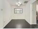 Bright living room featuring hardwood floors, ceiling fan, and a large window at 2865 S Fairfax St, Denver, CO 80222