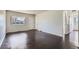 Large living room with hardwood floors and a large window providing ample natural light at 2865 S Fairfax St, Denver, CO 80222