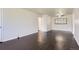 Bright living room featuring sleek dark hardwood floors, a ceiling fan and plenty of natural light at 2865 S Fairfax St, Denver, CO 80222