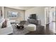 Stylishly furnished living room featuring hardwood floors, a large window, and neutral decor at 2865 S Fairfax St, Denver, CO 80222