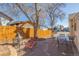 Brick patio with fire pit, seating area and wooden fence at 381 El Paso Ct, Denver, CO 80221