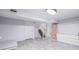 Spacious basement with gray vinyl flooring, white walls, and a staircase at 381 El Paso Ct, Denver, CO 80221