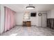 Finished basement area with custom cabinets, gray flooring, a TV and a window at 381 El Paso Ct, Denver, CO 80221