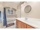 Well-lit bathroom featuring a vanity with an oval sink, tile accents, and a shower-tub combination at 381 El Paso Ct, Denver, CO 80221