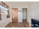 This is a bedroom with wood-look flooring, a closet and an open door to the hallway at 381 El Paso Ct, Denver, CO 80221