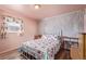 Charming bedroom with floral bedding and wood-like wall accents at 381 El Paso Ct, Denver, CO 80221