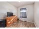 Simple bedroom with wood floors, a dresser, and a TV at 381 El Paso Ct, Denver, CO 80221