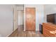 Bedroom with wood floors, double door closet and dresser at 381 El Paso Ct, Denver, CO 80221