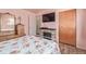 Bedroom with fireplace, wood-look floors, a ceiling fan, and a window at 381 El Paso Ct, Denver, CO 80221