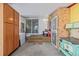 View of the enclosed patio featuring light walls, concrete floors, an antique stove and sliding glass doors at 381 El Paso Ct, Denver, CO 80221