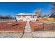 Tan house with red shutters, well-maintained lawn, and walkway at 381 El Paso Ct, Denver, CO 80221