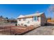 Ranch style home with red shutters, neat landscaping, and a walkway at 381 El Paso Ct, Denver, CO 80221