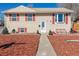 Charming two-story home featuring light-colored siding, red shutters, and a well-maintained front yard with mulch at 381 El Paso Ct, Denver, CO 80221