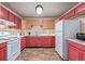 Well-equipped kitchen featuring wood and red cabinets, and modern appliances at 381 El Paso Ct, Denver, CO 80221