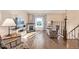 Bright living room featuring hardwood floors, a charming fireplace, and a large window providing natural light at 381 El Paso Ct, Denver, CO 80221