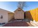 Tan colored storage shed with double doors at 381 El Paso Ct, Denver, CO 80221