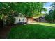 Large backyard showcasing a pergola, lush lawn, mature trees, and an outdoor seating area at 3047 N Milwaukee St, Denver, CO 80205